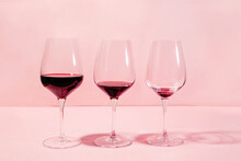 Mindful Drinking And Alcohol Cutback Concept. Three Glasses With Lowering Levels Of Red Wine Poured
