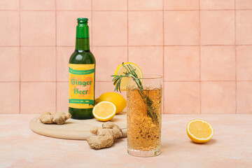 Wall Mural - Glass of fresh ginger beer with rosemary and lemon slice on beige background