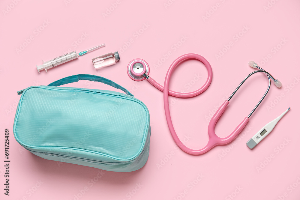 First aid kit on pink background