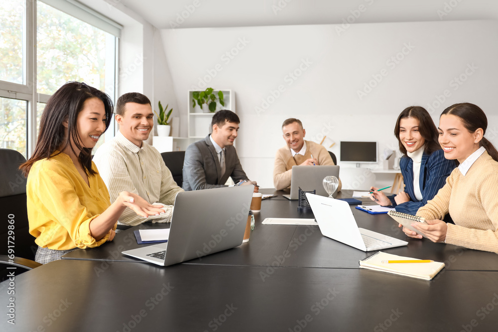 Business colleagues working at table in office
