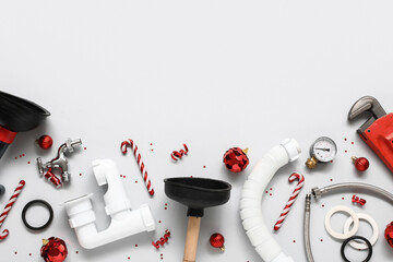 Wall Mural - Composition with plumber's items and Christmas decorations on light background