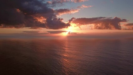 Wall Mural - flying to setting sun in dramatic clouds over atlantic ocean, 4k