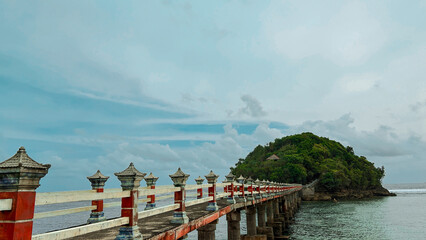 small island with a bridge in the Indonesian sea.