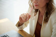 © DragonImages - Pensive mature female entrepreneur working on business plan