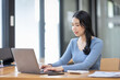 © David - Asian Business woman using calculator and laptop for doing math finance on an office desk, tax, report, accounting, statistics, and analytical research concept