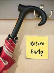 Hanging umbrella with stick note written Retire Early - refers to practice of retiring before reaching usual employer's official retirement age - stop working before 60