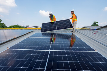 Men technicians carrying photovoltaic solar moduls on roof of factory on the morning. Installing a Solar Cell on a Roof. Solar panels on roof. Workers installing solar cell power plant eco technology.