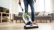 © mariiaplo - Young Man Cleaning room with Vacuum Cleaner at home
