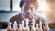 A man is focused looking at the chessboard.