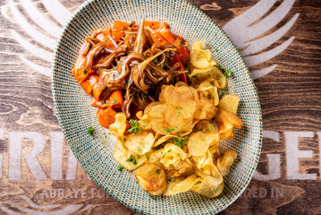 Poster -  appetizer pig pork ears with potato chips and carrot