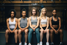 Group Of Diverse Sporty Girls Sitting At Sports Hall.