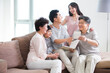 © Blue Jean Images - Happy family looking at photo album