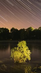 Wall Mural - Timelapse Night Sky Above River. Star Trails On Night Sky Background. Star Lines Move In Sky. Night Sky Turns Into Morning. Amazing Starry Effects. From Dusk To Dawn. Dawn Is Coming. Time Lapse Time