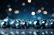  a group of blue christmas balls sitting on top of a table next to a pile of silver and gold ornaments.