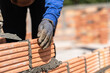worker with trowel and bricks