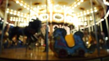 Defocused Nighttime Christmas Carousel Spinning With Warm Lights