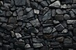  a close up of a rock wall that looks like it has been made out of black and white rocks with a brown spot in the middle.