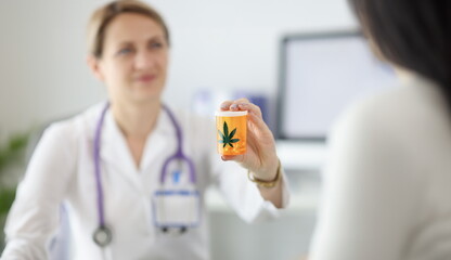 Canvas Print - Doctor holding jar of marijuana pills closeup. Drug addiction treatment concept