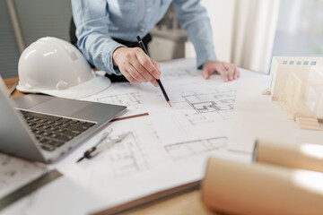 Wall Mural - Architects interior designer hands working with Blue prints and documents for a home renovation for house design.