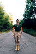 © ADDICTIVE STOCK - Caucasian male military soldier in uniform standing in attention position on road against forest