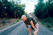 © ADDICTIVE STOCK - Exhausted middle aged military commando resting while standing on road