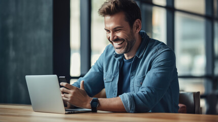 Wall Mural - A man in a casual outfit works on a laptop in his office