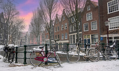 Poster - City scenic from snowy Amsterdam the Netherlands at sunset