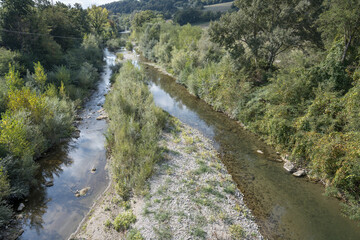 Wall Mural - Fiora river green banks and shoal south of Mirafiora bridge, near Pitigliano, Italy