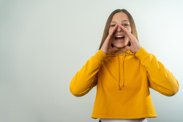 Surprised happy beauty young girl looking copy space in excitement. Expressive facial expressions. Presenting some product. Beautiful girl act like a telling secret Isolated on grey background