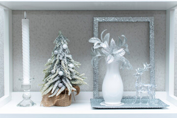 Wall Mural - Still life with a candle, christmas tree, vase with flowers and glass deer