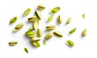 Falling pistachio nuts isolated on white background.