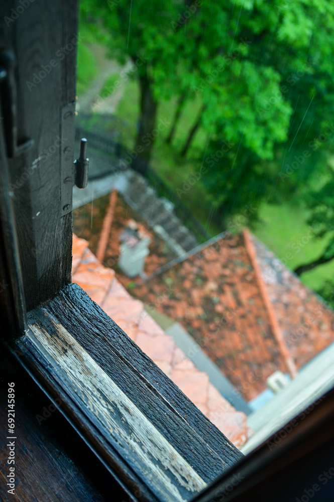 Old wooden window frame with frame, window glass and roof with roof tiles in the Dracula Castle, Bran Castle, Törzburg or Castelul Bran in Bran Village
