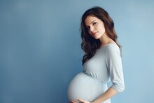 Young Beautiful Pregnant Woman On Blue Background