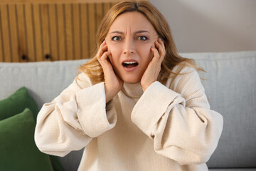 Wall Mural - Scared mature woman at home, closeup