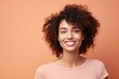 © Werckmeister - closeup portrait of young happy woman looking in camera on peach fuzz background