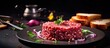 Beefsteak tartar with red onion rings ready to eat with toasted bread. Copy space image. Place for adding text or design