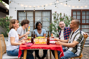 Wall Mural - Multi-ethnic family having fun, enjoy party outdoors in the garden. 