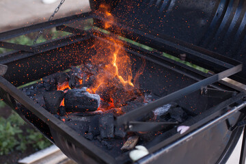 Photograph of charcoal grill ignited. Food preparation concept.