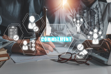 Wall Mural - Commitment concept, Business team analyzing income charts and graphs on office desk with commitment icon on virtual screen, conclusion, competence, behaviour, trust, and success.