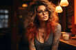 Portrait of a cool tattooed young hipster woman with glasses sitting in a pub and looking away