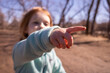Girl pointing a finger at something out of view
