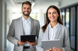 © id512 - two happy professional business people team woman and man workers standing with digital tablet at corporate office
