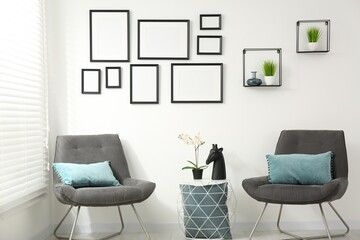 Sticker - Stylish room interior with empty frames hanging on white wall