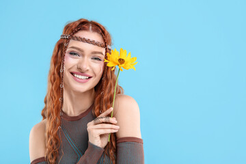 Poster - Beautiful young hippie woman with sunflower on light blue background, space for text