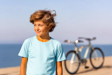 Sticker - Young boy standing next to bike on beach.