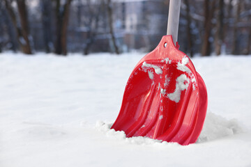 Wall Mural - Snow shovel with wooden handle outdoors. Space for text