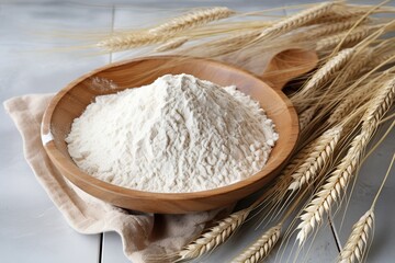 Wall Mural - Flour in wooden bowl with wheat ears on table