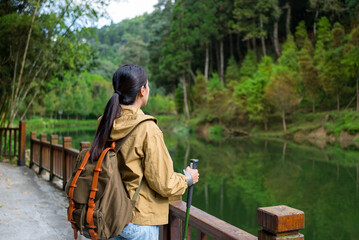 Poster - Hiking woman walk along the lakeside in the forest trail