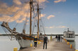 People walk in the port on the Åland Islands at sunset.
