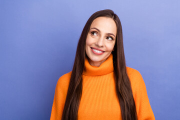 Wall Mural - Portrait of pretty woman brown hair wearing orange pullover looking empty space at winter sale clothes isolated on violet color background